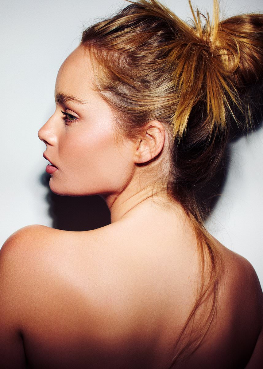 Beauty portrait of Chloe Bau in profile with her hair swept into a loose updo